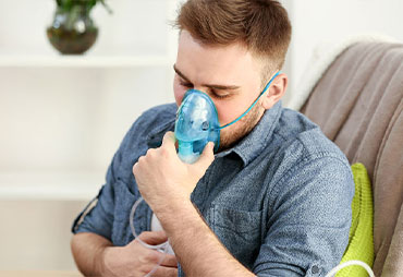 Man with asthma using inhalator