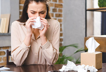 Woman with allergies researching chiropractic care for allergy relief