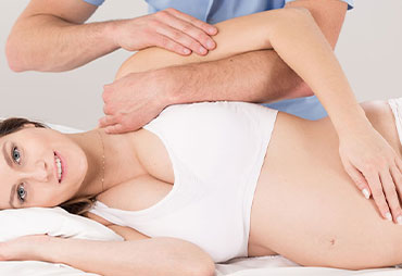 Pregnant woman getting a chiropractic adjustment