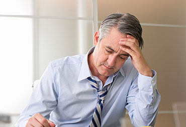 Man stressed at work in need of chiropractic care for stress relief