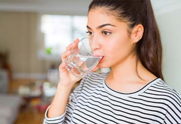 Healthy girl drinking a nice glass of water