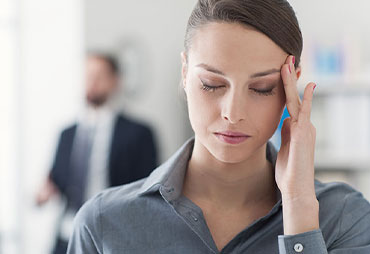 Woman with triggered migraine