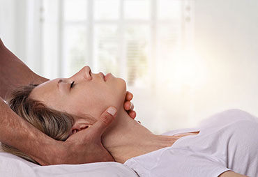 Woman getting neck adjusted by chiropractor