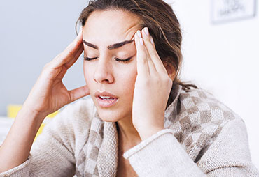 Woman suffering from intense headache