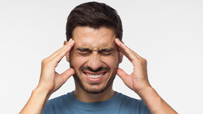 Man suffering from severe headaches